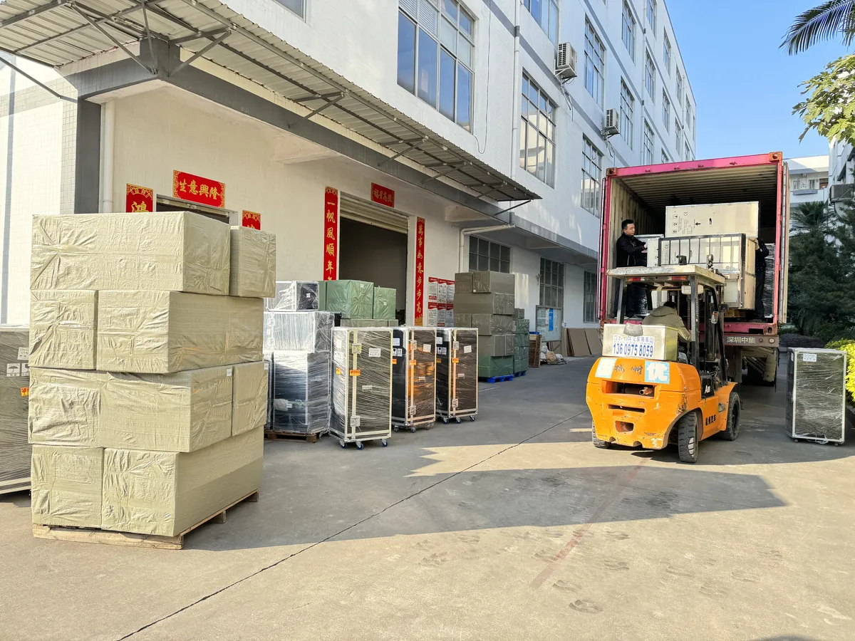 Beauty machine cartons and flight cases loaded into an export container