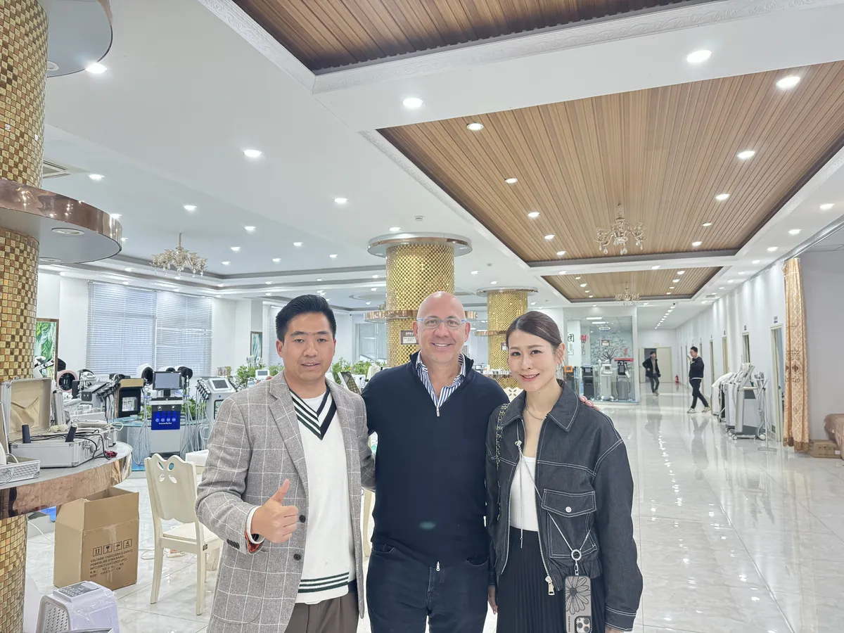 Overseas buyer reviewing FQBeauty beauty machines and OEM options in the showroom